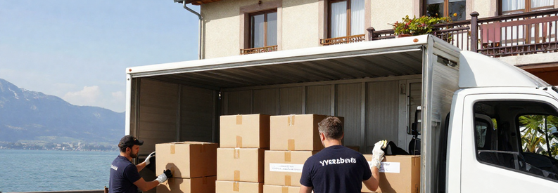 Types Demenagement Yverdon Les Bains Reseau Déménageurs chargeant meubles et cartons devant immeuble résidentiel à Yverdon-les-Bains